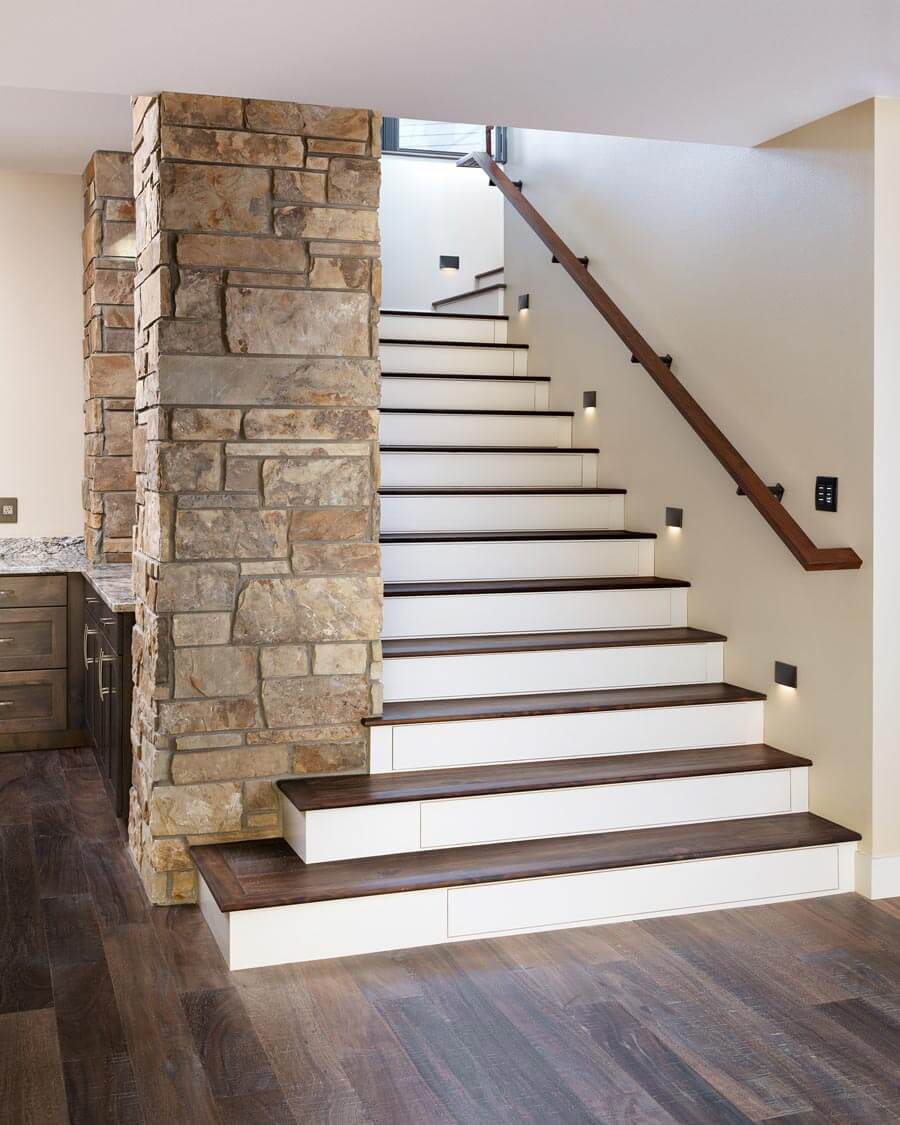 staircase with hidden wine drawers - Waterford custom home