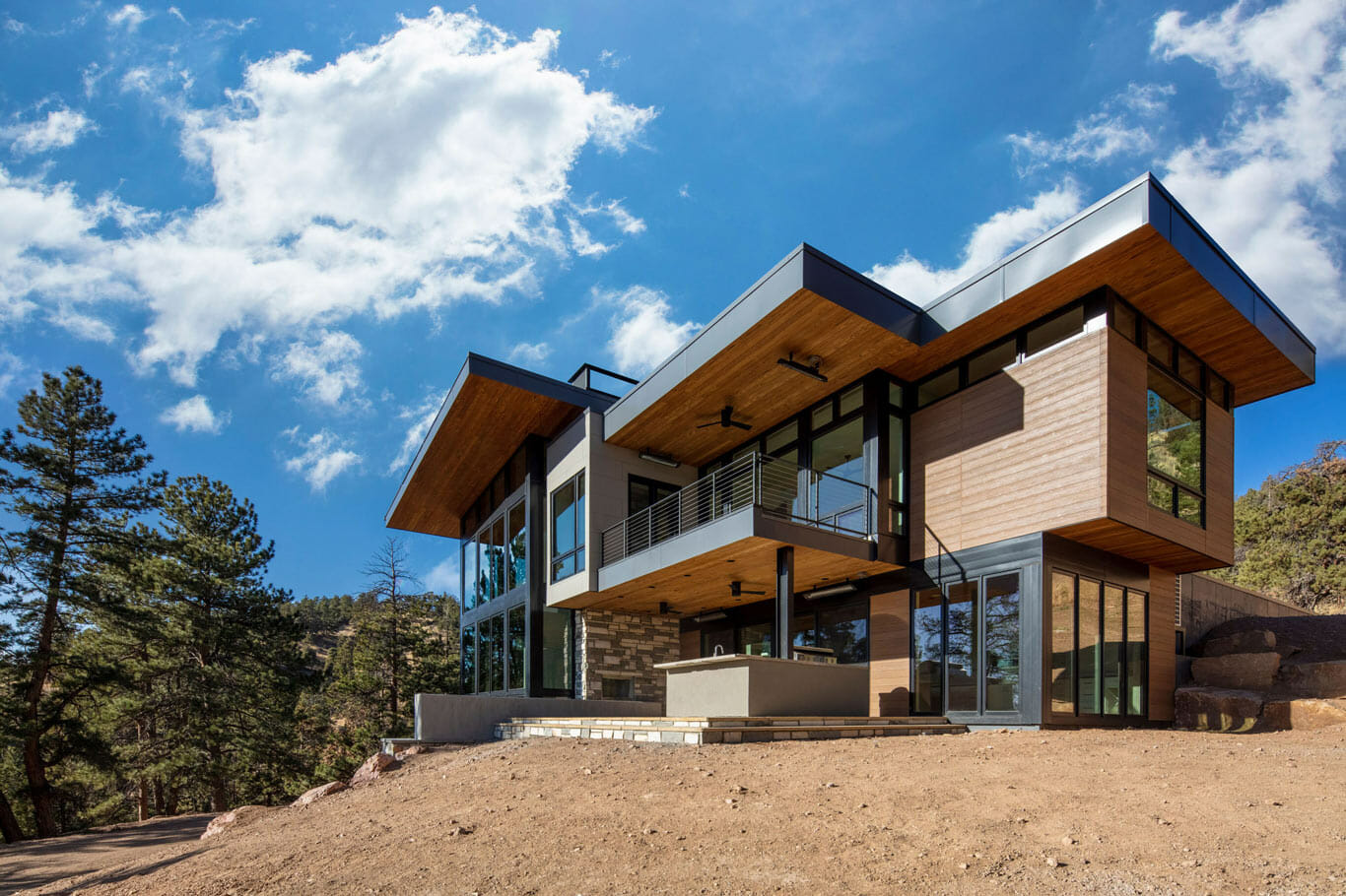 custom home in the mountains with a deck and patio