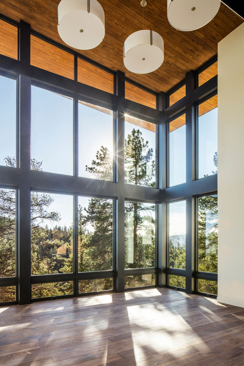 custom mountain home with floor to ceiling windows