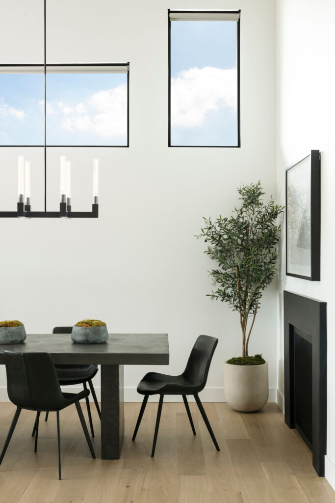 Wildflower custom home - dining room heavy wood table and minimalist gas fireplace