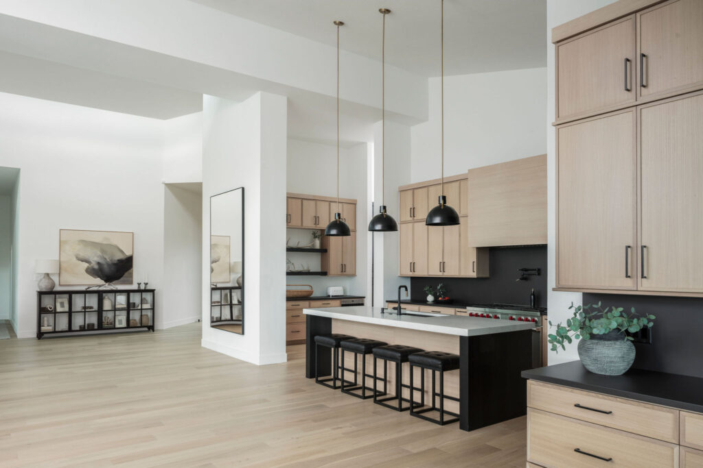 Wildflower custom home - kitchen with custom cabinetry, island with bar seating