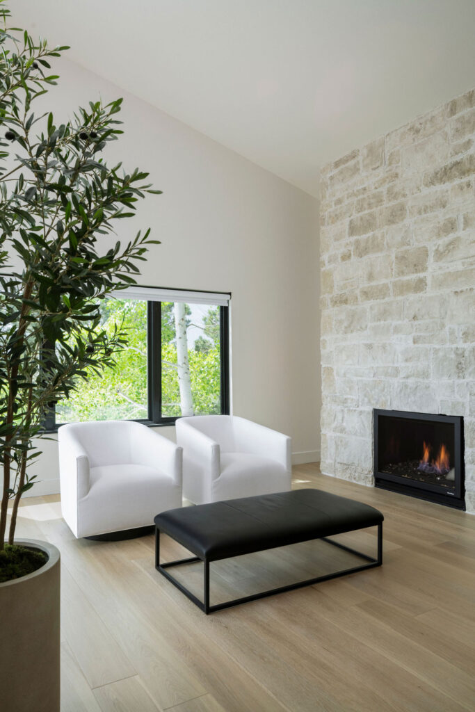 Wildflower custom home - living room with Hill Country Texas limestone fireplace with schmeared mortar to give it a rustic, aged appearance