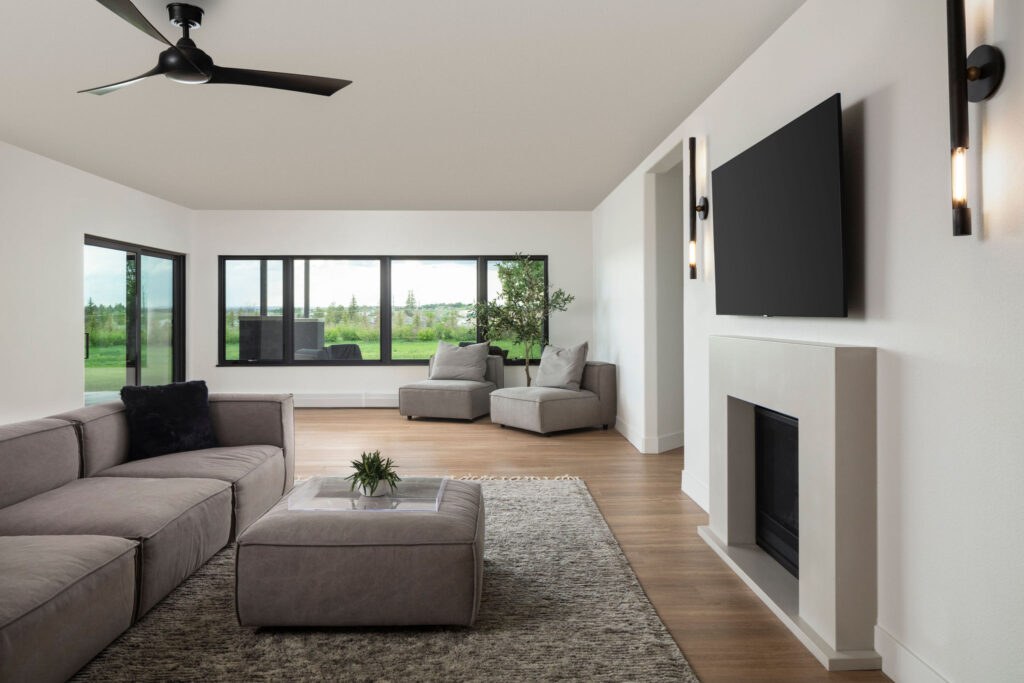 Wildflower custom home - living room setting showing gas fireplace, views of the meadow outside