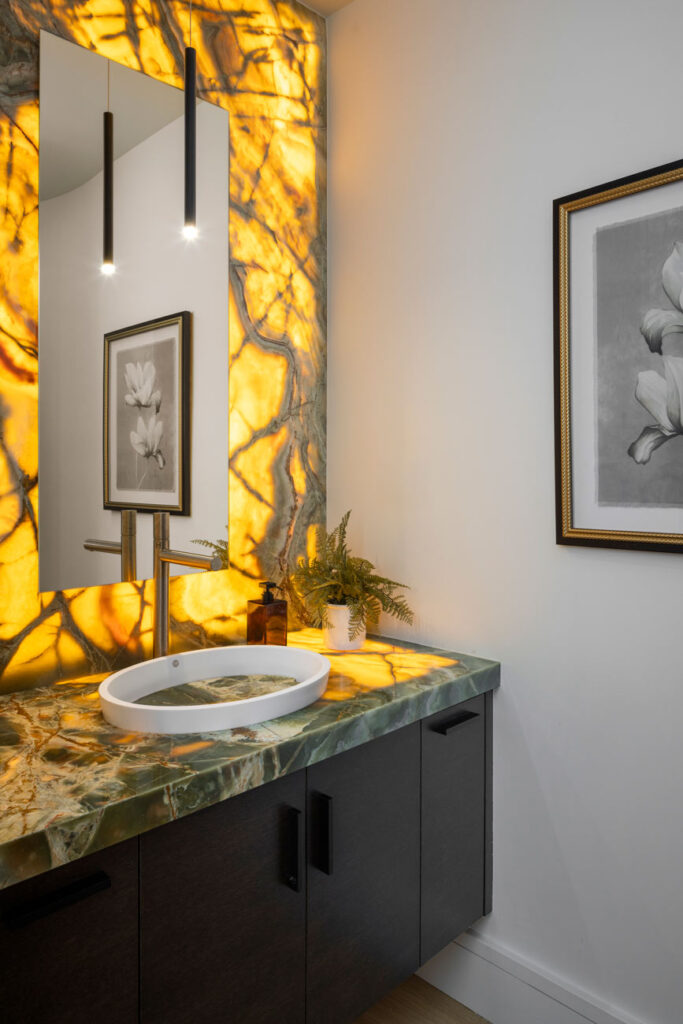 Backlight onyx backsplashes in the Cheateau Brot remodeled bathroom.