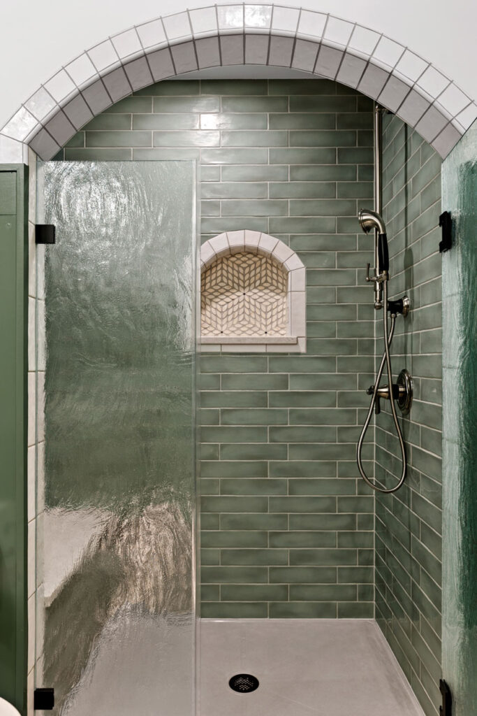 walk-in shower with green subway tile