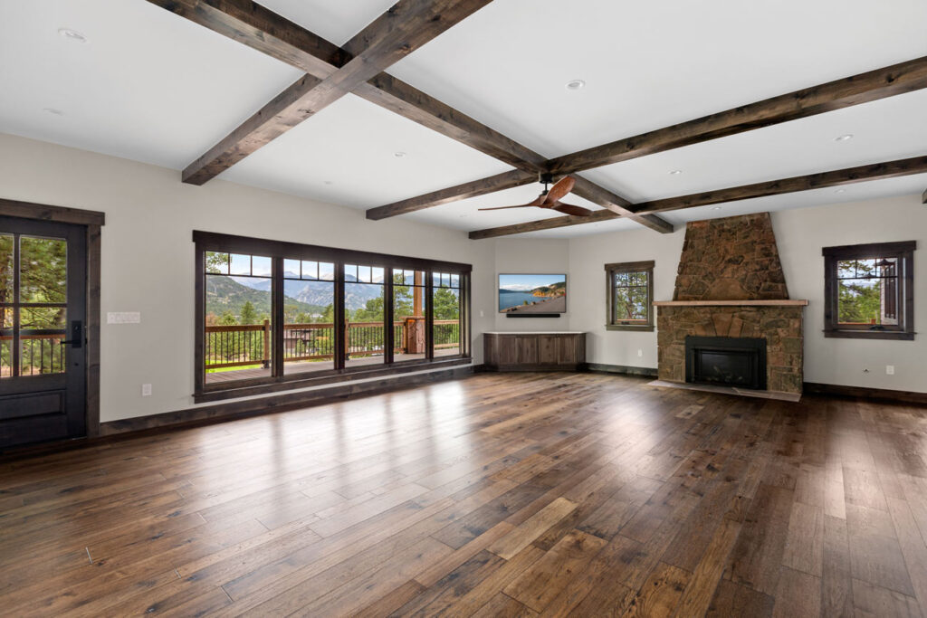 Living room view of custom remodeled cabin in Estes Park, featuring knotty alder doors, trim, and heavy beams.