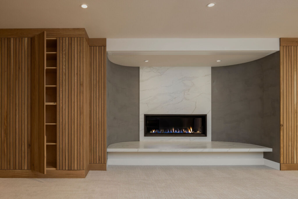 basement remodel with fireplace reading nook and hidden cabinets
