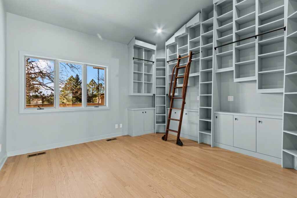 Master bedroom walk-in closet with sliding ladder