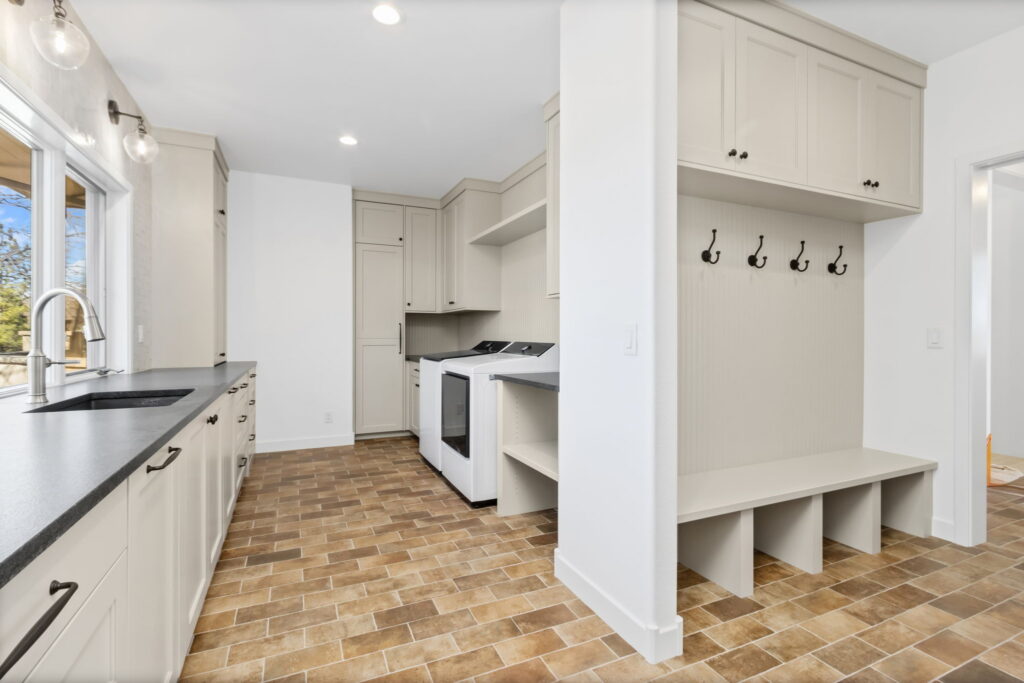 mudroom with sink and hooks for coats