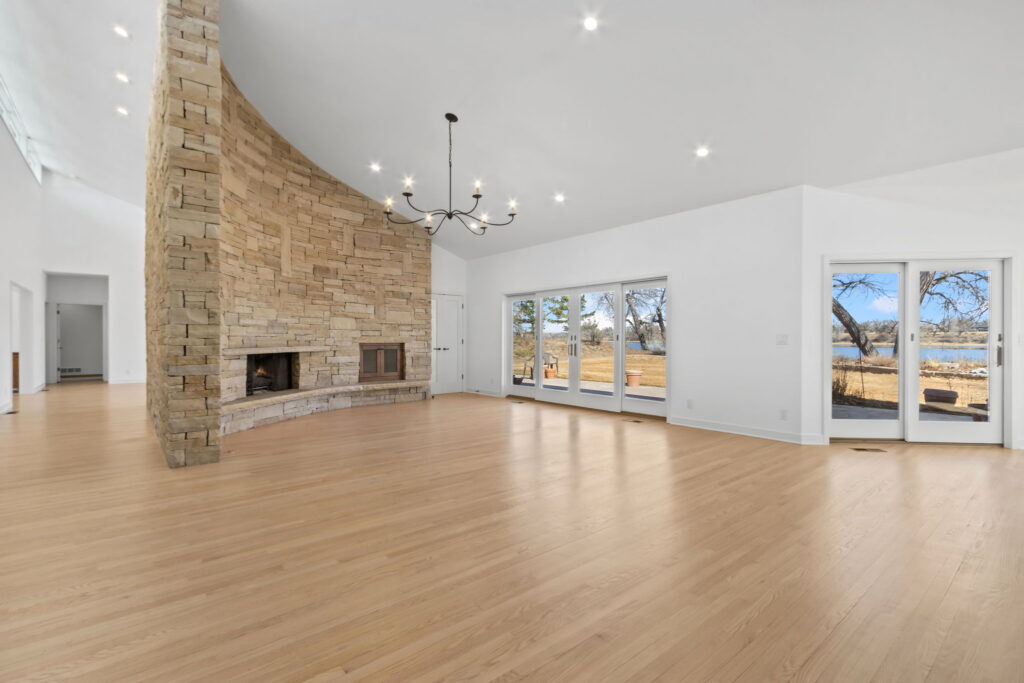 living room with curved stone wall for fireplace