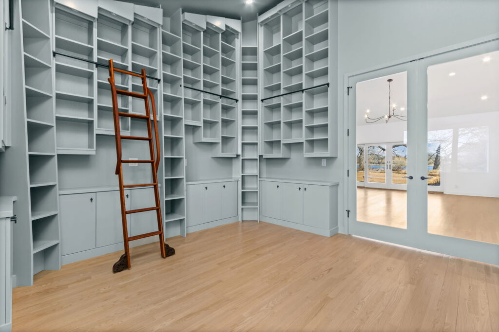 Master bedroom walk-in closet with sliding ladder