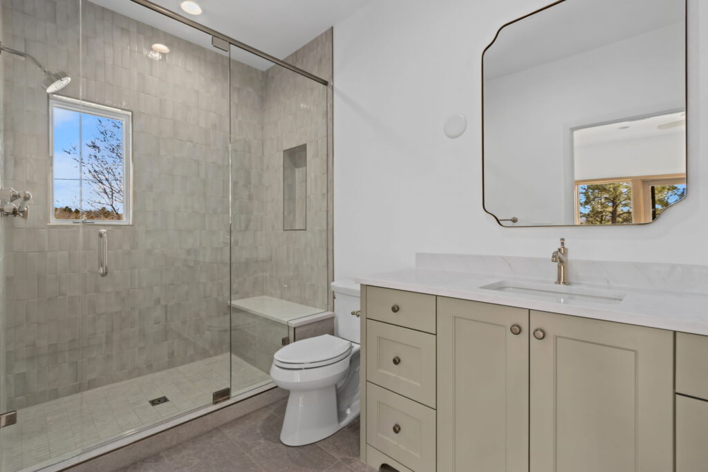 tan and white bathroom with walkin shower